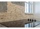 Close up of kitchen featuring a stone backsplash and glass stovetop at 311 W Fern St, Tampa, FL 33604