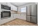 Modern kitchen with stainless steel refrigerator and built in oven at 311 W Fern St, Tampa, FL 33604