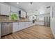 Bright, newly renovated kitchen with stainless steel appliances, white cabinets, and hardwood floors at 311 W Fern St, Tampa, FL 33604