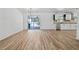 Bright living space with wood floors opens to kitchen and screened lanai via sliding glass doors at 311 W Fern St, Tampa, FL 33604