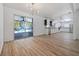Bright living space with wood floors opens to kitchen and screened lanai via sliding glass doors at 311 W Fern St, Tampa, FL 33604