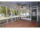 Screened-in porch featuring an eye-catching tile floor and a ceiling fan, plus views of the backyard at 311 W Fern St, Tampa, FL 33604