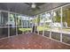Screened-in porch with an eye-catching tile floor, a ceiling fan, and views of the lush backyard at 311 W Fern St, Tampa, FL 33604