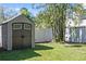 Backyard shed with dark brown doors and a white frame. Surrounded by bamboo at 311 W Fern St, Tampa, FL 33604