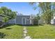 Backyard featuring two sheds with a stone pathway leading to them at 311 W Fern St, Tampa, FL 33604