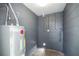 Utility room with grey cinder block and a water heater at 311 W Fern St, Tampa, FL 33604