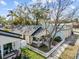 This aerial view shows the charming property with a white picket fence, inviting porch, and mature trees at 322 11Th N Ave, St Petersburg, FL 33701