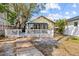 Serene backyard featuring a deck, white picket fence, and lush greenery at 322 11Th N Ave, St Petersburg, FL 33701