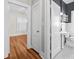 Hallway view of an updated bathroom with black and white tile floors and new fixtures at 322 11Th N Ave, St Petersburg, FL 33701