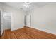 Bedroom featuring hardwood floors, white walls, a ceiling fan, and two doors at 322 11Th N Ave, St Petersburg, FL 33701