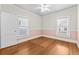 Bedroom featuring hardwood floors, white walls, pink trim, and two windows at 322 11Th N Ave, St Petersburg, FL 33701