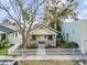Charming yellow home with a white picket fence, enhancing its curb appeal, and a cozy, welcoming entrance at 322 11Th N Ave, St Petersburg, FL 33701