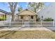 Charming yellow home with a white picket fence, enhancing its curb appeal, and a cozy, welcoming entrance at 322 11Th N Ave, St Petersburg, FL 33701