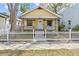 Quaint yellow bungalow with a white picket fence and charming front porch at 322 11Th N Ave, St Petersburg, FL 33701