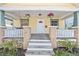 Inviting front porch with hanging plants, swing, and classic design enhances the curb appeal of this charming home at 322 11Th N Ave, St Petersburg, FL 33701