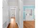 Hallway with hardwood floors, white walls and trim, built-in storage, and view of other rooms at 322 11Th N Ave, St Petersburg, FL 33701