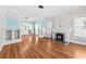 Open-concept living room with hardwood floors, fireplace, and bright blue accent walls at 322 11Th N Ave, St Petersburg, FL 33701