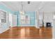 Bright living room with hardwood floors, a decorative fireplace, and modern chandelier at 322 11Th N Ave, St Petersburg, FL 33701