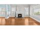 Cozy living room featuring hardwood floors, a white fireplace, and bright natural light at 322 11Th N Ave, St Petersburg, FL 33701