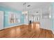 Open living space with hardwood floors, bright blue walls, and a modern chandelier at 322 11Th N Ave, St Petersburg, FL 33701