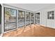Sunroom featuring wood floors, white trim, and views of the backyard and deck through large windows at 322 11Th N Ave, St Petersburg, FL 33701