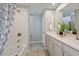 Stylish bathroom features a shower over tub, double sink vanity, and neutral color palette at 3473 Timber Crossing Ave, Brandon, FL 33511