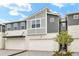 Modern townhome boasting two-car garage, stylish gray and white exterior, and newly installed landscaping at 3473 Timber Crossing Ave, Brandon, FL 33511