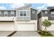 Modern two-story townhome with a gray and white color scheme and a two-car garage at 3473 Timber Crossing Ave, Brandon, FL 33511