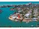 Aerial view of waterfront home, lush landscaping, private dock, and beautiful water views at 351 S Julia Cir, St Pete Beach, FL 33706