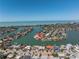 Captivating aerial view of a waterfront home with boats and dock, showcasing coastal living at its finest at 351 S Julia Cir, St Pete Beach, FL 33706
