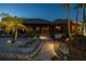 Charming backyard featuring sand, tiki hut, lush greenery, offering a serene outdoor retreat at 351 S Julia Cir, St Pete Beach, FL 33706