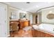 Bright bathroom featuring a spacious vanity area, jacuzzi, and charming interior design at 351 S Julia Cir, St Pete Beach, FL 33706