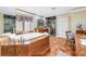 Luxurious bathroom featuring a large tub, a separate glass-enclosed shower, and a vanity with wood cabinets at 351 S Julia Cir, St Pete Beach, FL 33706