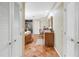 Bright bathroom boasts white cabinets, a large mirror, terracotta tiled floors, and a glass enclosed shower at 351 S Julia Cir, St Pete Beach, FL 33706