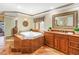 Elegant bathroom boasts a soaking tub, natural light, and a beautiful vanity area at 351 S Julia Cir, St Pete Beach, FL 33706