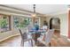 Bright dining area with a bay window offering panoramic views of the tropical surroundings at 351 S Julia Cir, St Pete Beach, FL 33706