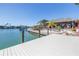 Inviting waterfront tiki home with a private dock and lush landscaping at 351 S Julia Cir, St Pete Beach, FL 33706