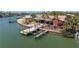 Waterfront property featuring a private dock with boat lift and outdoor entertainment space at 351 S Julia Cir, St Pete Beach, FL 33706