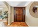 Inviting foyer with decorative tile flooring, wooden front door, and an arched entryway at 351 S Julia Cir, St Pete Beach, FL 33706