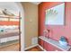 Inviting hallway with an ornate table and an arched doorway that leads into a bedroom with a ceiling fan at 351 S Julia Cir, St Pete Beach, FL 33706
