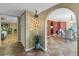 Hallway featuring unique decorative lighting and arched entryways into the living and dining areas at 351 S Julia Cir, St Pete Beach, FL 33706