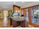 Open kitchen features an island with granite countertops and sliding glass doors to the outside area at 351 S Julia Cir, St Pete Beach, FL 33706