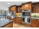 This kitchen features custom cabinets, granite countertops, and modern stainless steel appliances at 351 S Julia Cir, St Pete Beach, FL 33706
