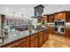 Chef's kitchen with custom wood cabinets, granite countertops, stainless appliances, and a center island at 351 S Julia Cir, St Pete Beach, FL 33706