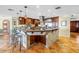 Expansive kitchen features a large island with bar seating, custom cabinets, and a stainless steel range hood at 351 S Julia Cir, St Pete Beach, FL 33706