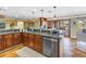 This kitchen has custom cabinets, granite countertops, stainless appliances, and a breakfast bar at 351 S Julia Cir, St Pete Beach, FL 33706