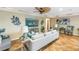 Comfortable living room with decorative ceiling fan, tile floors, and stylish contemporary furniture at 351 S Julia Cir, St Pete Beach, FL 33706