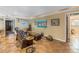 Neutral living room with tiled floors, comfortable seating, and decorative accents on the walls at 351 S Julia Cir, St Pete Beach, FL 33706