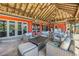 Inviting outdoor lounge area with stylish wicker furniture and a cozy thatched roof, perfect for relaxing by the water at 351 S Julia Cir, St Pete Beach, FL 33706