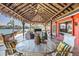Waterfront covered patio offers a dining table, seating, and great views of the water at 351 S Julia Cir, St Pete Beach, FL 33706